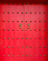 Front view of traditional Chinese main door with brass lion head door knocker. Traditional and beautiful art of Chinese culture.