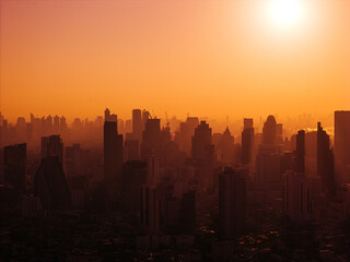 Aerial view of Bangkok city during amazing red sunrise. The silhouettes of tall buildings and...