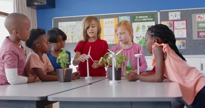 In school, children discussing wind turbines and plants in classroom project