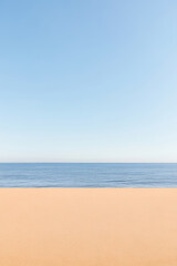 Obraz premium Calm seashore with gentle waves and clear blue sky on a serene day