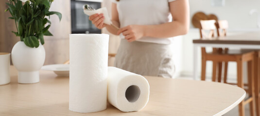 Rolls of paper towels on table in kitchen, closeup