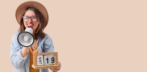Young woman with calendar and megaphone on beige background with space for text. Artist as Outlaw Day