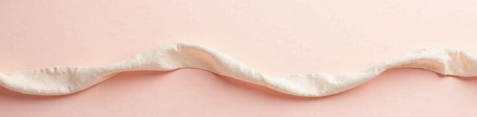 Fototapeta premium Thin linen rope loosely draped on a pale surface , aesthetic, minimal