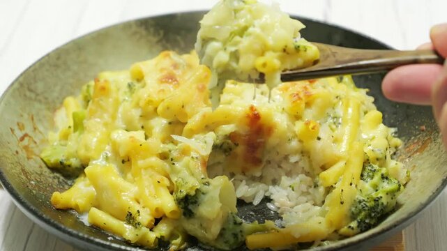 Gratin (doria) made with vegetables, macaroni, cheese and rice. Looks warm and delicious