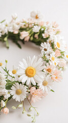 Obraz premium white and pink daisies and flowers in a wreath on white background
