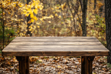 Naklejka premium Wooden table in autumn forest with colorful leaves on the ground and trees in the background