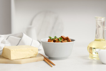 Bowl with pieces of fried tofu cheese and micro green on white background