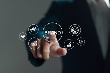 Brand management concept. Businessman touching BRAND icon on virtual screen for Strategic planning, positioning and building a strong brand image