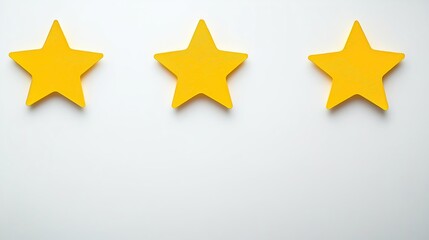 Fototapeta premium Three yellow stars on a white background, top view, with copy space for a customer review. Quality service award