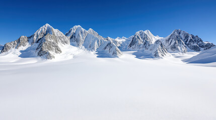 Aerial view of snow covered mountain range under clear blue sky