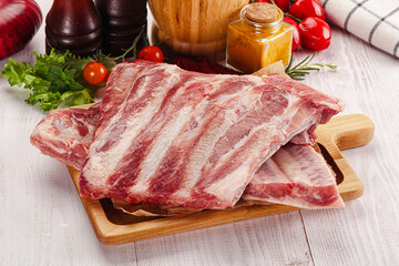 Raw pork ribs over board