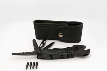 Compact black multi-tool with adjustable wrench, serrated saw blade, knife, and screwdrivers...