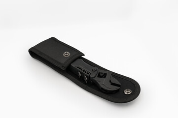 Folded black multi-tool stored in a sleek black nylon case with snap closure, placed on a clean white background..