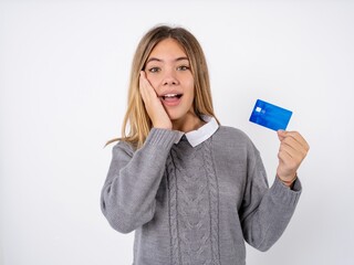 Astonished positive Beautiful teen girl wearing grey sweater arm face hold bank plastic card...