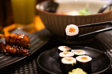 Salmon Sushi with Chopsticks in Japanese Dining Setting