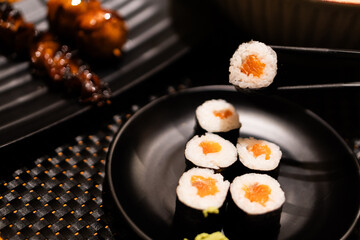 Salmon Sushi with Chopsticks in Japanese Dining Setting