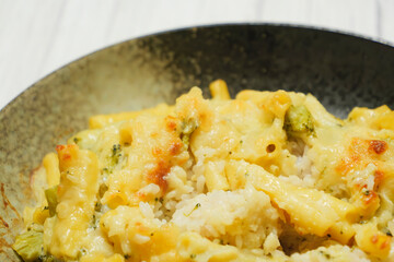 Gratin (doria) made with vegetables, macaroni, cheese and rice. Looks warm and delicious