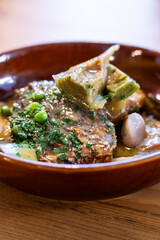 Corvina in green sauce with artichokes and 
