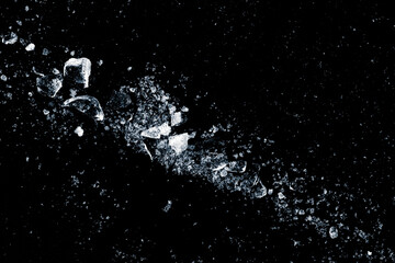 Ice, crushed on a black background. Shards of crushed ice.