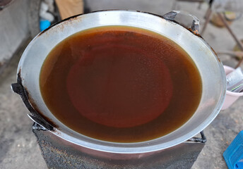used cooking oil in a large frying pan. unhealthy food concept