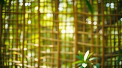 Naklejka premium A blurred background image with an abstract woven pattern of light brown branches, the grid design creates a sense of depth, with a soft green foliage behind