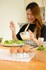 A woman enjoy making salad in the kitchen