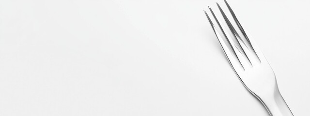 Elegant silver fork, matte finish, positioned diagonally, contrasting against a clean white backdrop, showcasing refined dining aesthetics