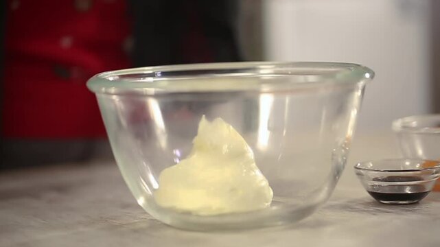 Closeup shot of putting butter in bowl.