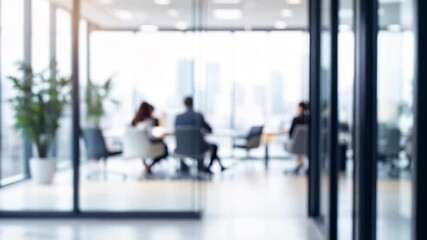 Blurred office meeting through glass walls. Modern corporate workspace with professionals in discussion. Open plan interior design for collaboration