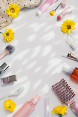 Beauty products background flat lay with skincare, haircare and makeup items on white