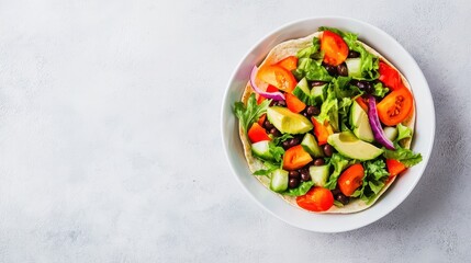 A vibrant salad featuring fresh vegetables like tomatoes, cucumbers, and greens, served in a bowl, perfect for a healthy meal.