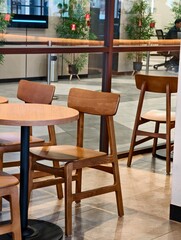 Modern Cafe Seating with Wooden Chairs and Table in a Bright Interior
