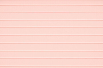 Pastel pink surface with corrugated cardboard like ribbed texture