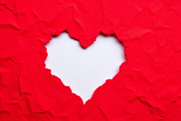 Torn red crumpled paper with heart shape cut out