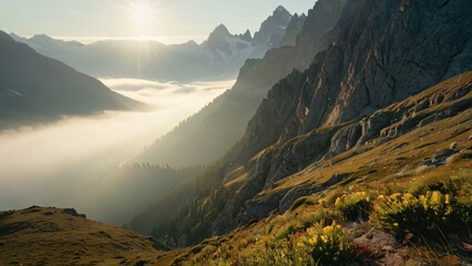 Foggy Mountain Pass at Sunrise with Mist and Sunlit Peaks