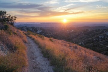 Hiking trail overlooking mountains during golden hour sunset