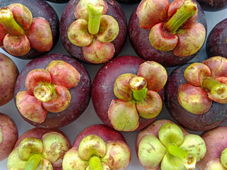 Mangosteen on the market with bright light portrait.  © Vhilandary