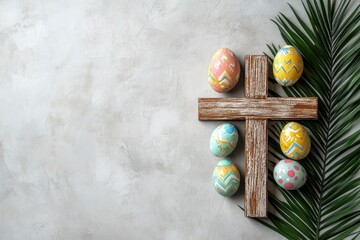 Wooden cross, painted Easter eggs and palm leaf on light grey background, space for text 