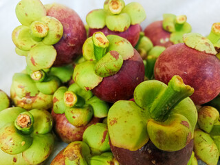 Mangosteen on the market with bright light portrait © Vhilandary