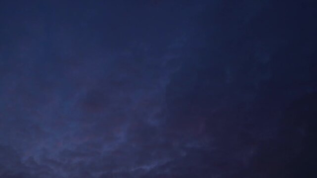 Purple clouds transforming into dark night sky