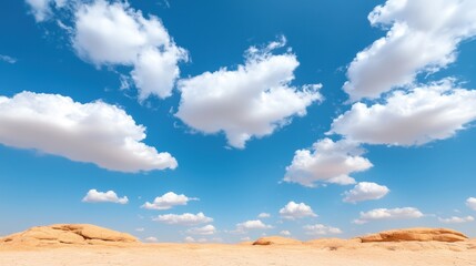 A desert landscape with a blue sky and white clouds