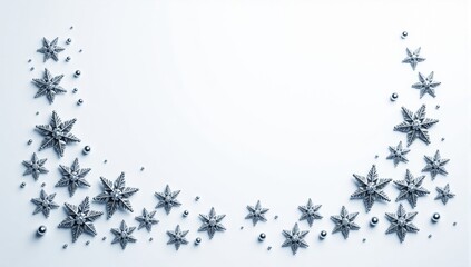Silver christmas snowflakes and pearls forming a border on white background