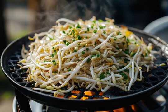 Korean side dishes mung bean sprouts and soy bean sprout salad beside the grilling basket