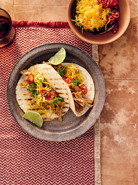 Delicious Mexican Tacos Served on a Decorative Plate With Fresh Toppings and Lime Wedges