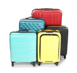 Many closed colorful suitcases isolated on white