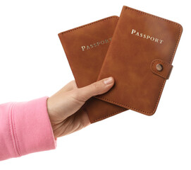 Woman holding passports in bright covers on white background, closeup
