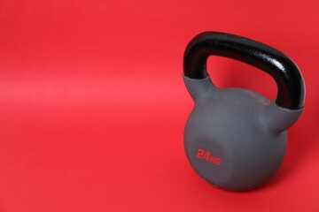 One kettlebell on red background. Space for text