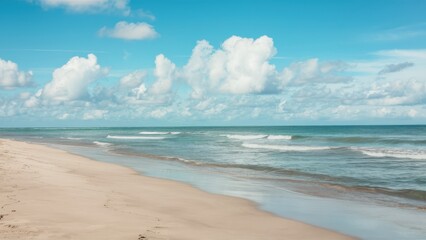 Fototapeta premium Serene tropical beach, turquoise ocean waves, soft sandy shore, fluffy white clouds, clear blue sky, peaceful coastline, gentle surf, tranquil seascape, sun-drenched landscape, idyllic vacation scene,
