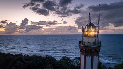 Aerial view of light beam from lighthouse by Sea.