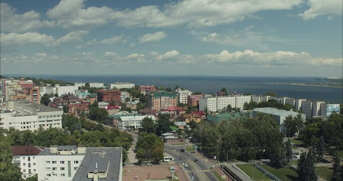 Cityscape by Volga river under cloudy sky